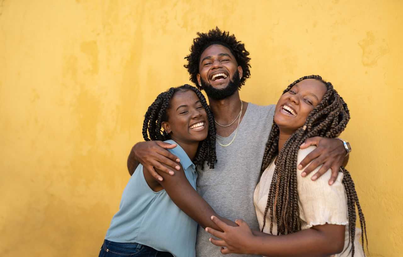 Group of young people hugging and smiling